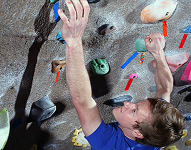 Male climbing rockwall